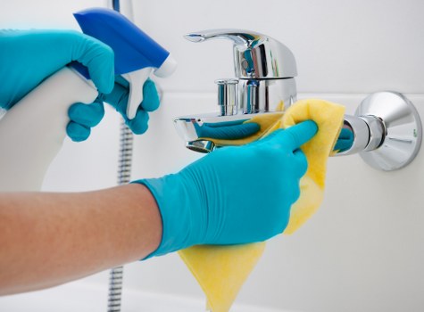 After builders cleaning team polishing windows and surfaces after construction