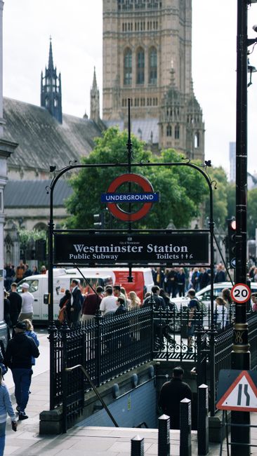 Close-up of a beige stone wall displaying a white and black sign indicating 'BELL YARD WC2' in the City of Westminster, with an additional yellow sign below warning about 24-hour CCTV operation and pr